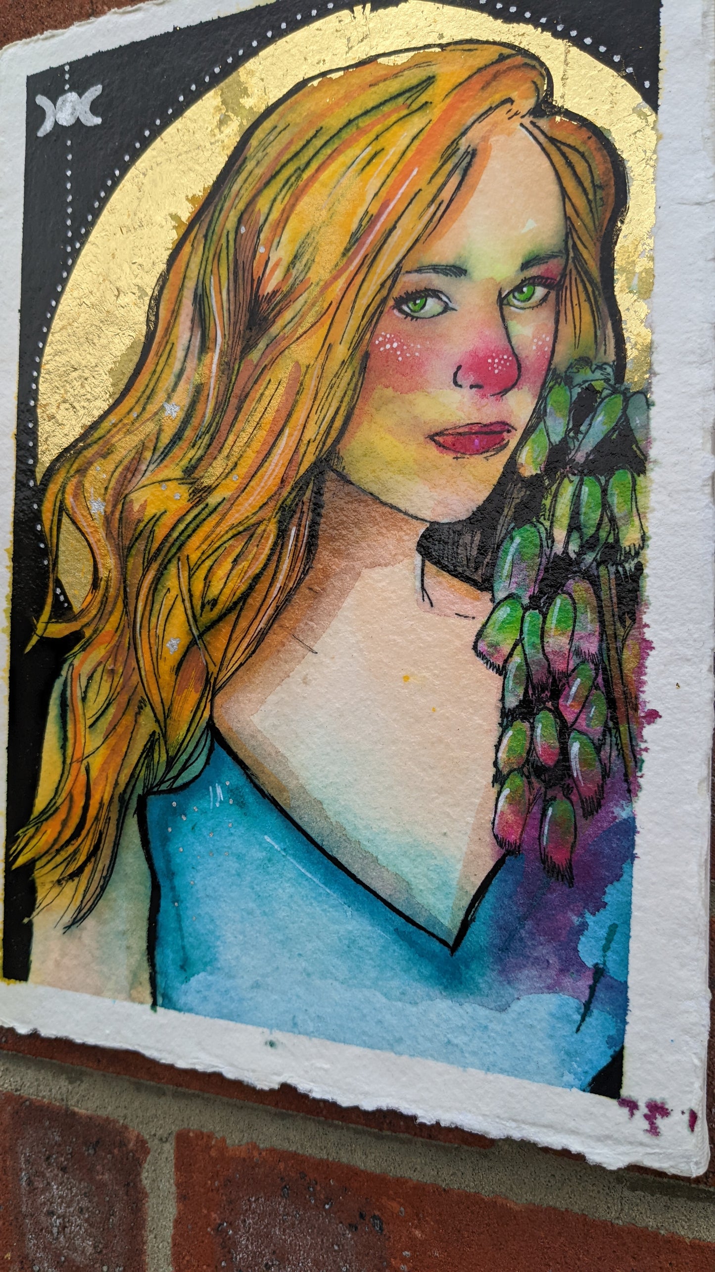 full frontal image of the witch character freya, with gold leaf and fly agaric detail, with her Freya, inks and watercolour painting by Dianne Bowell, an original painting from the Middlesbrough studio of British female artist Dianne Bowell. 